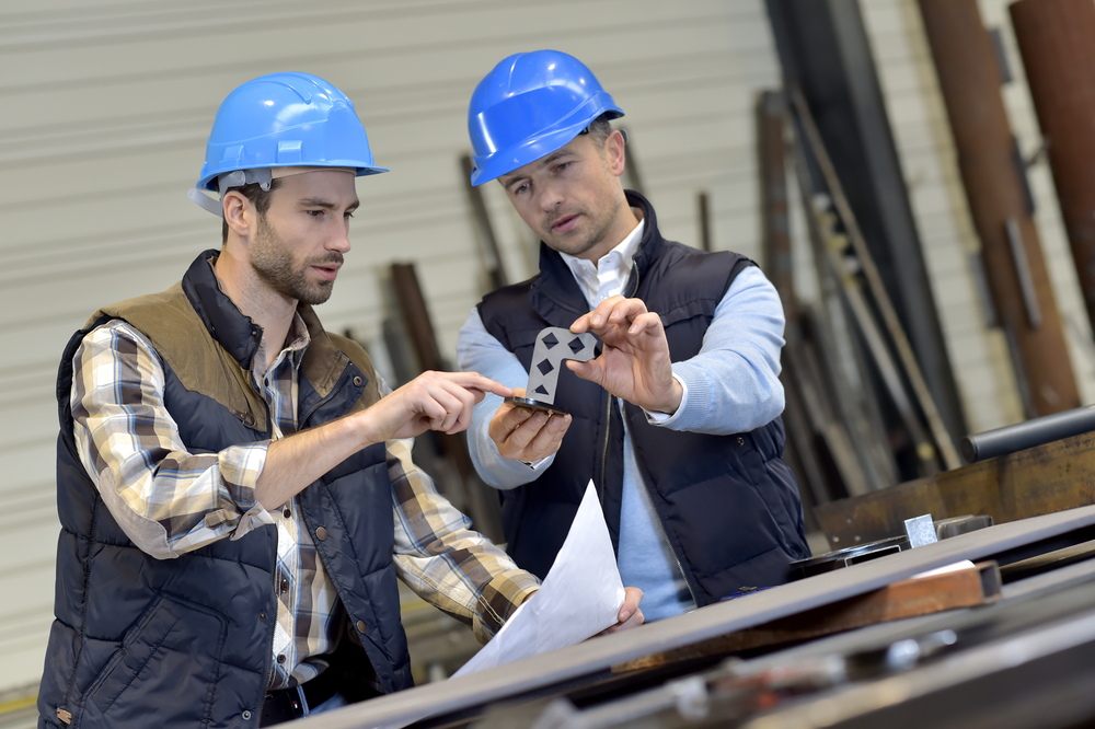 Engineer with mechanical worker checking on production-1