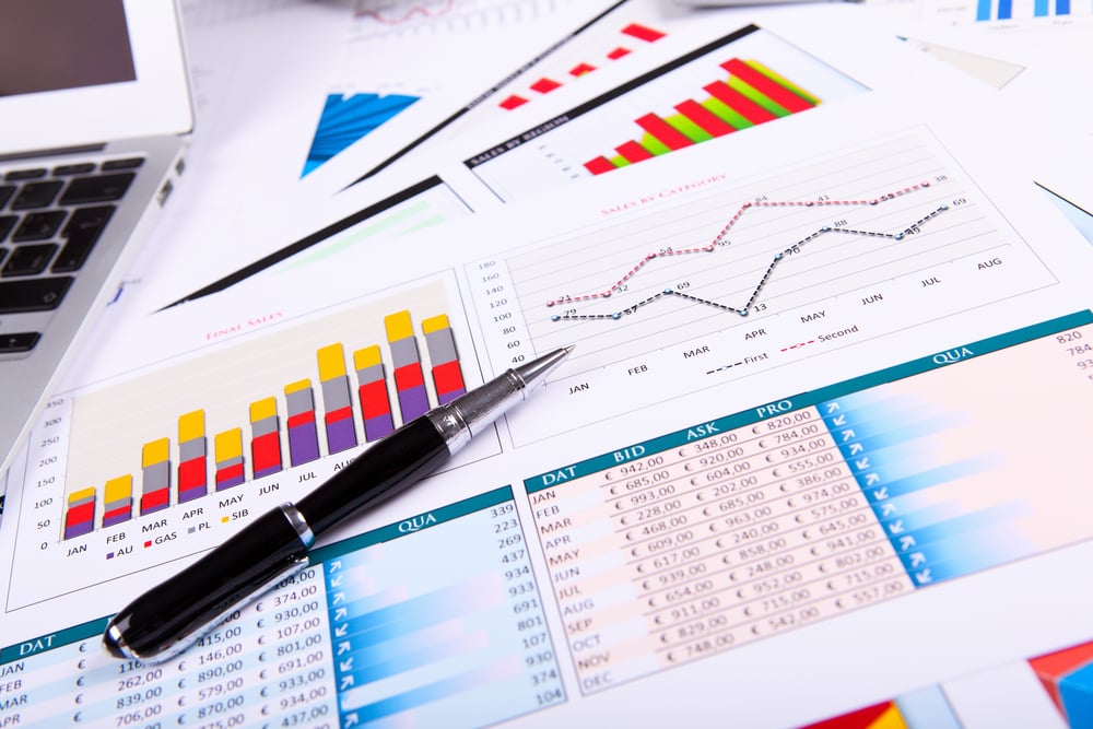 Financial paper charts and graphs on the table